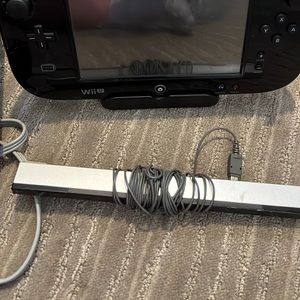 Black Nintendo Wii U with 4 controller, nunchucks, power cables, and games